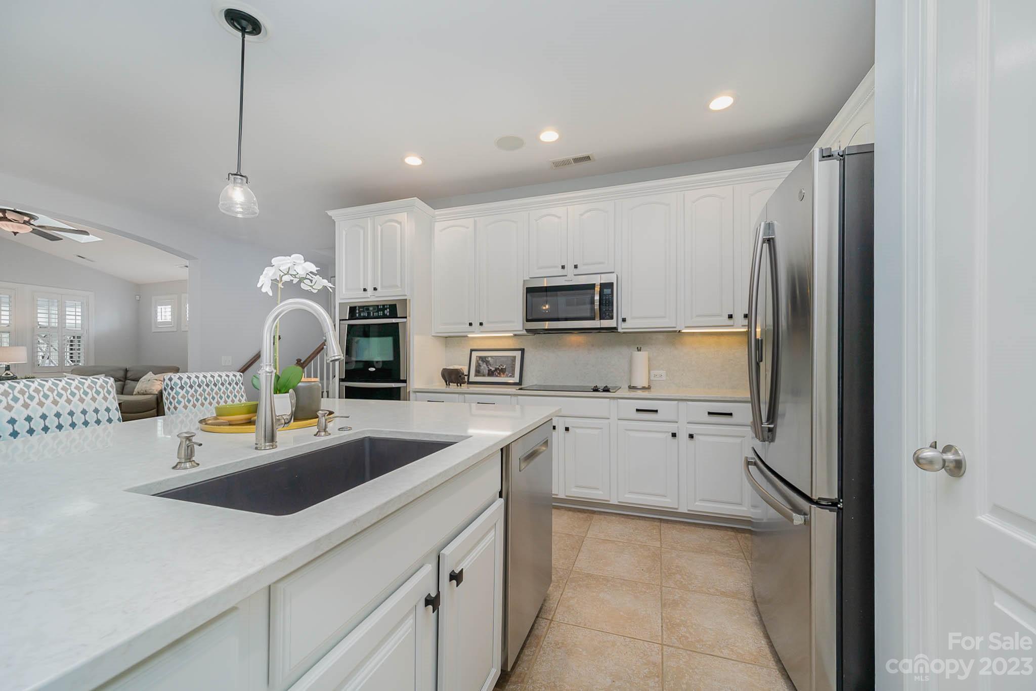 4922 Spur Ranch Road Charlotte, NC 28277 - Photo 5 of 33 a kitchen with stainless steel appliances granite countertop a refrigerator sink and stove