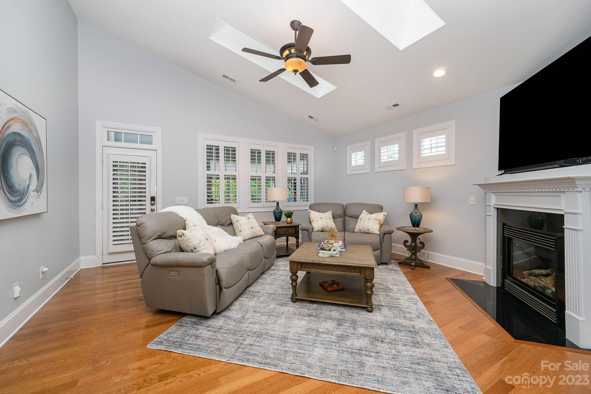 4922 Spur Ranch Road Charlotte, NC 28277 - Photo 8 of 33 a living room with furniture fireplace and a flat screen tv