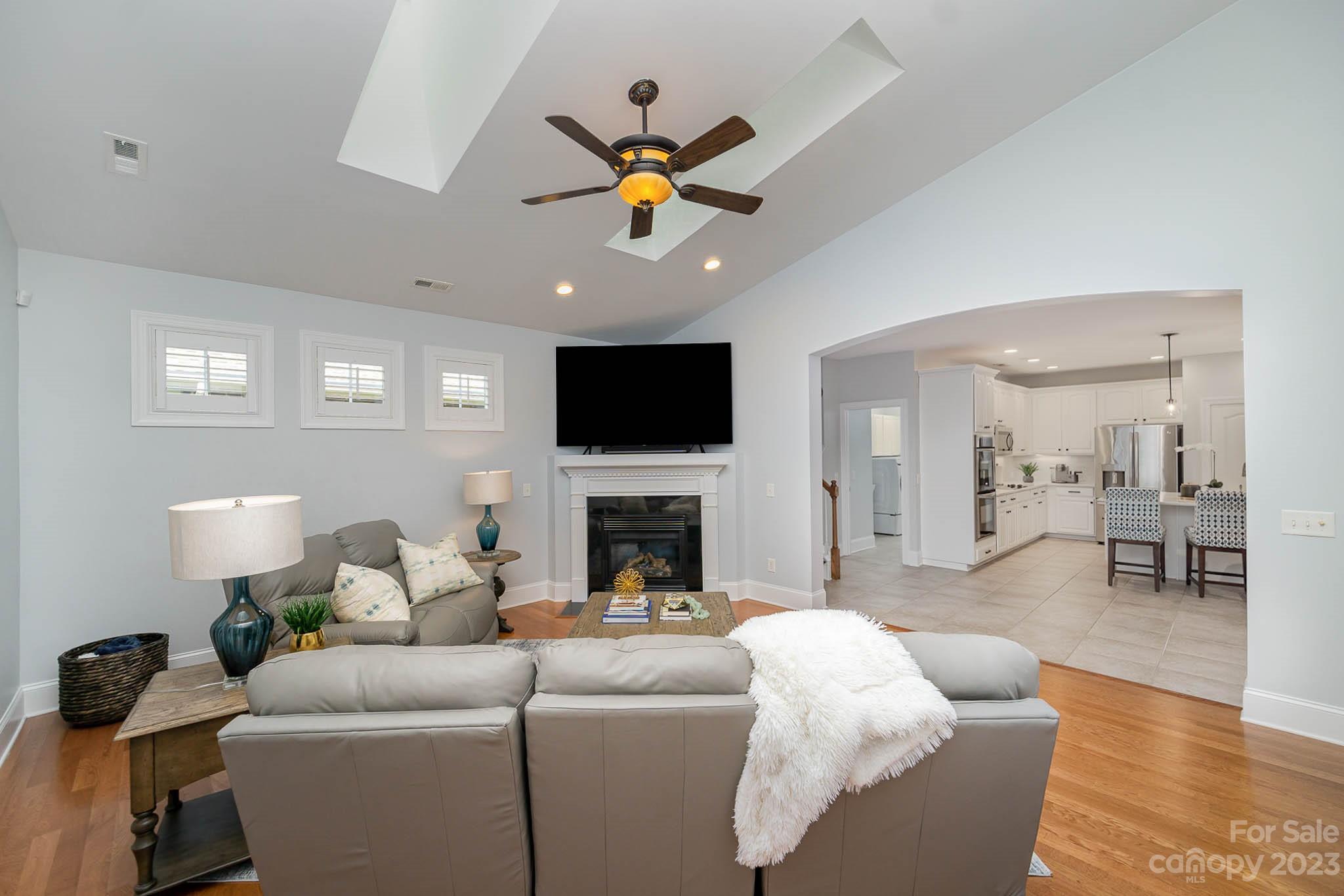 4922 Spur Ranch Road Charlotte, NC 28277 - Photo 9 of 33 a living room with furniture a fireplace and a flat screen tv