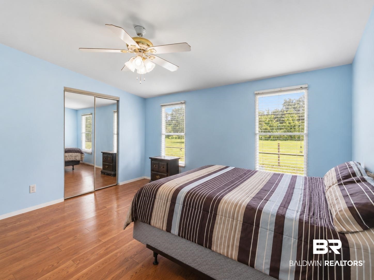 26788 Feely Road Elberta, AL 36530 - Photo 11 of 31 Spacious room featuring wood-finish flooring, two windows, and mirrored closet doors