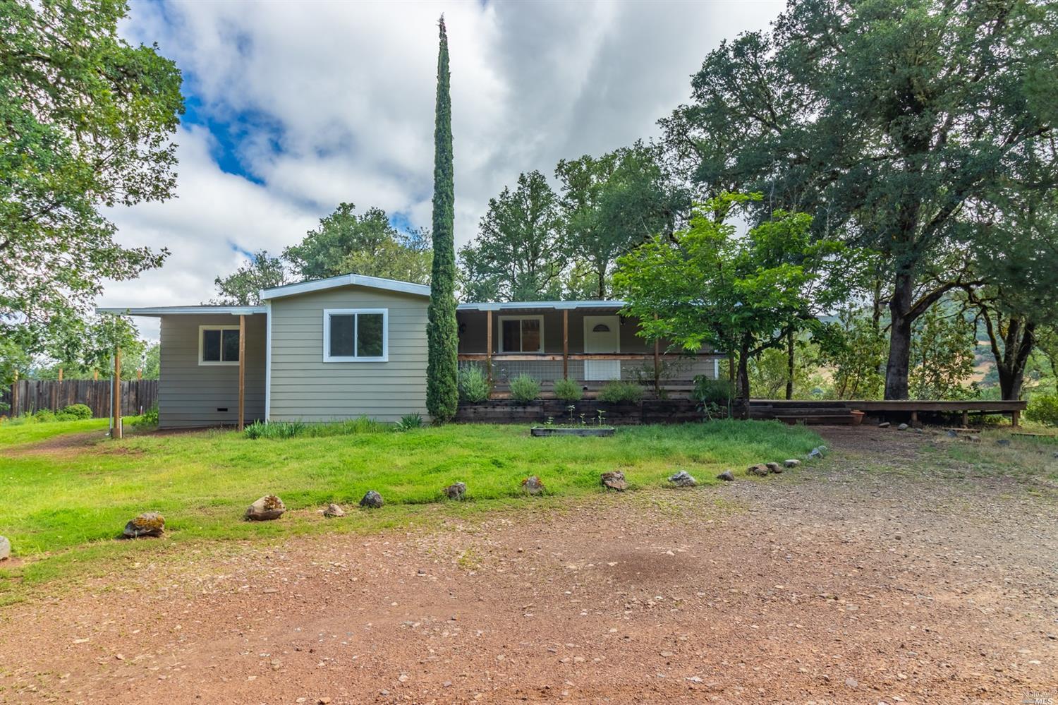 2201 Rd B Redwood Valley, CA 95470 - Photo 1 of 1 a backyard of a house with plants and large tree
