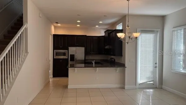 a kitchen with stainless steel appliances a refrigerator and a sink