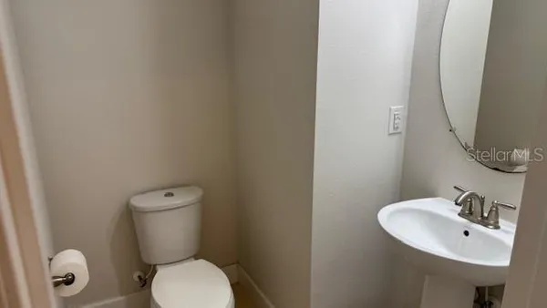 a white toilet sitting next to a bathroom sink