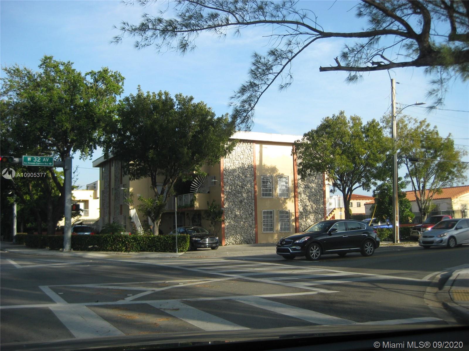 a view of a city street lined with lots of trees
