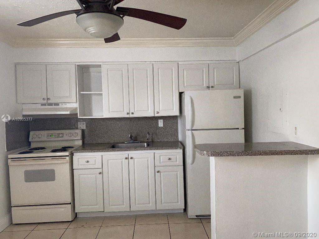 11 Southwest 32nd Avenue, Unit 1 Miami, FL 33135 - Photo 5 of 14 a kitchen with white cabinets and white appliances
