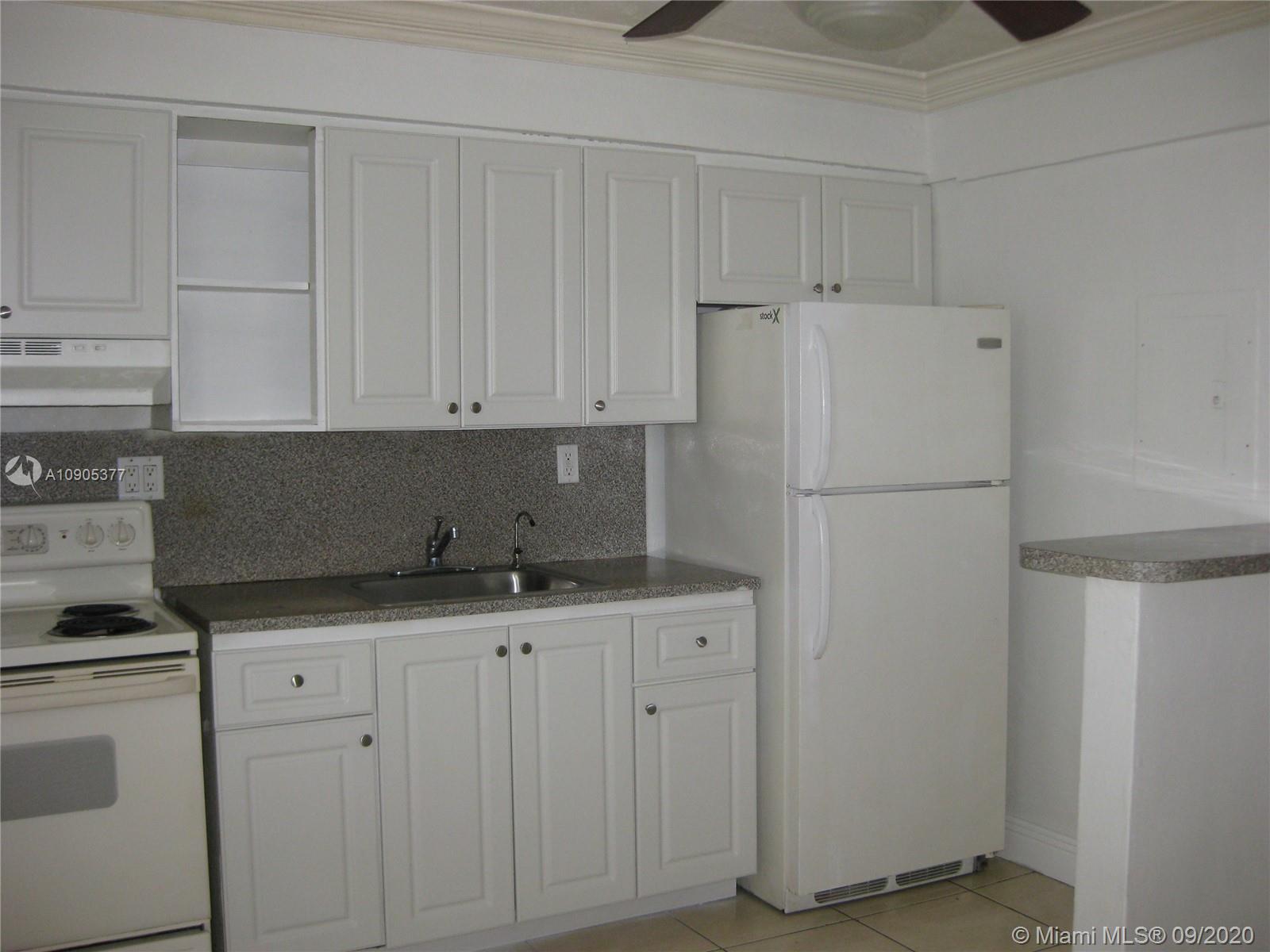 11 Southwest 32nd Avenue, Unit 1 Miami, FL 33135 - Photo 6 of 14 a kitchen with appliances a sink and cabinets