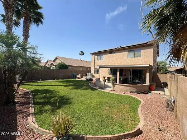 a view of a house with swimming pool and sitting area