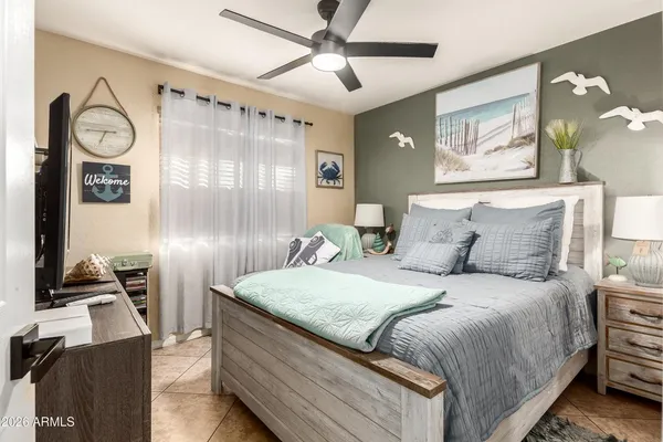 a bedroom with a bed and a chandelier