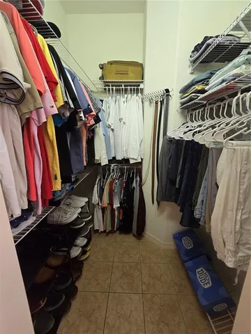 a spacious bathroom with a tub a sink and mirror