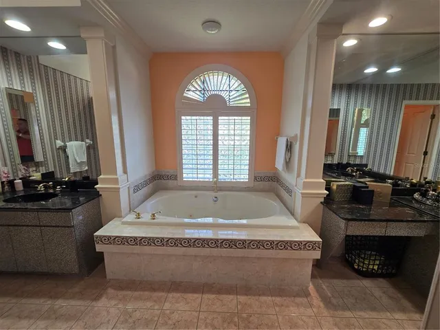 a large bathroom with a large tub and sink