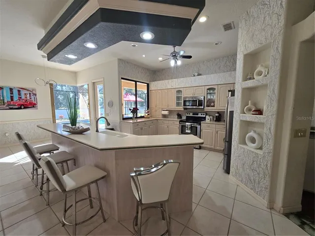 a large white kitchen with a large island