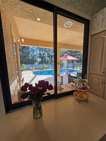 a living room with stainless steel appliances kitchen island granite countertop a sink and cabinets