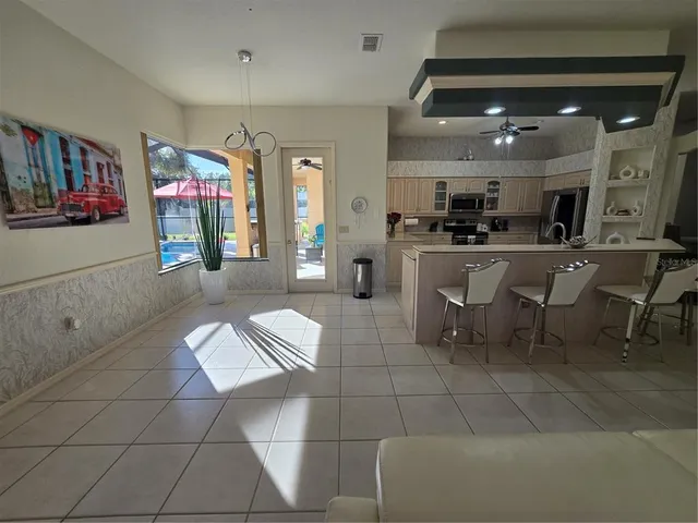 a living room with furniture a ceiling fan and a fireplace