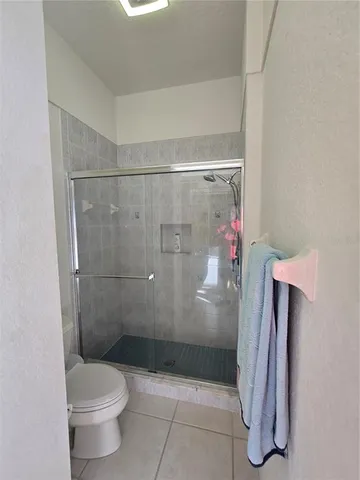 a white toilet sitting next to a bath tub