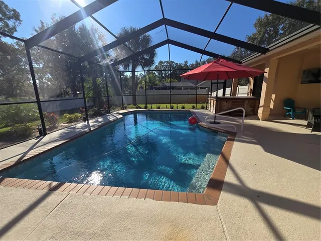 a view of a patio with a table and chairs under an umbrella