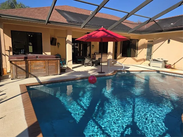 a view of a patio with chairs and umbrellas