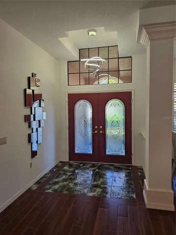 a view of room with wooden floor and fan