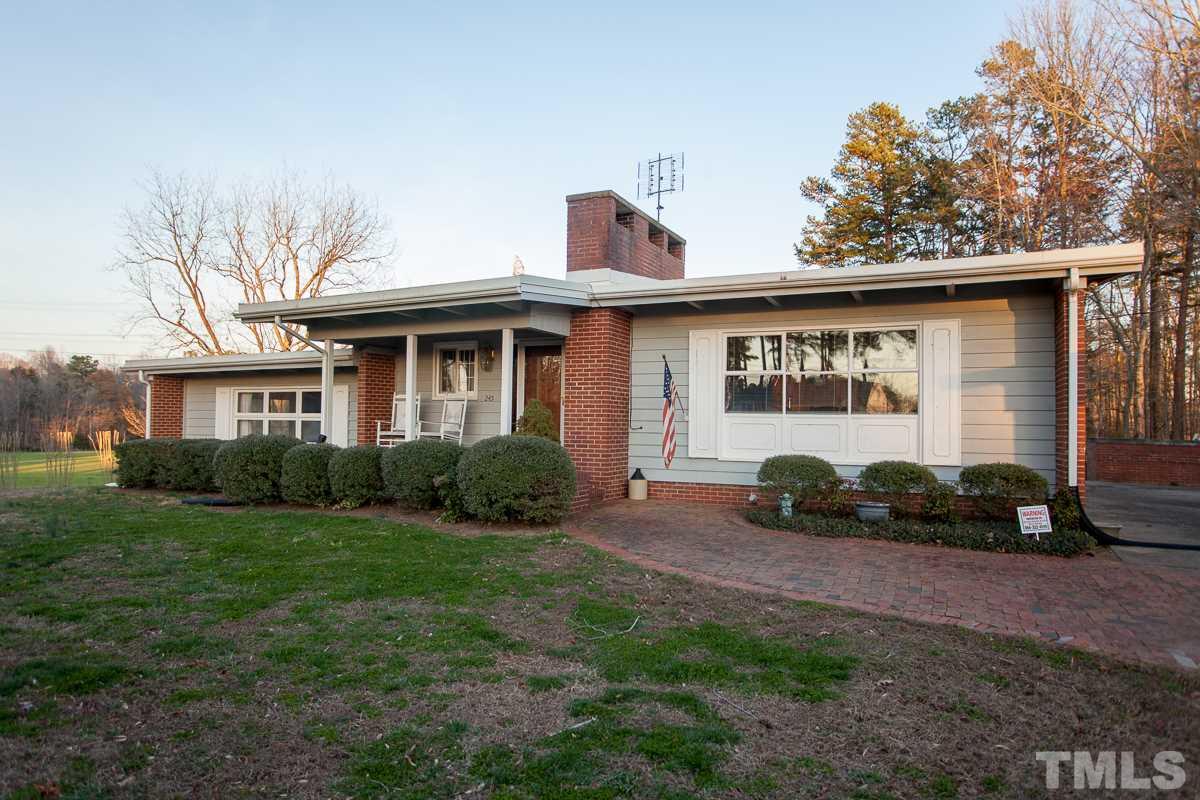 245 Weldon Wrenn Road Roxboro, NC 27574 - Photo 1 of 25 a front view of a house with a yard and garage