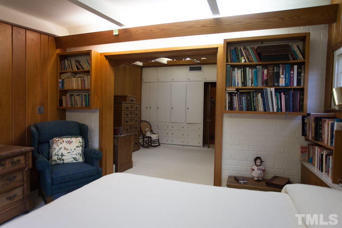 245 Weldon Wrenn Road Roxboro, NC 27574 - Photo 12 of 25 a bedroom with a bed and a book shelf