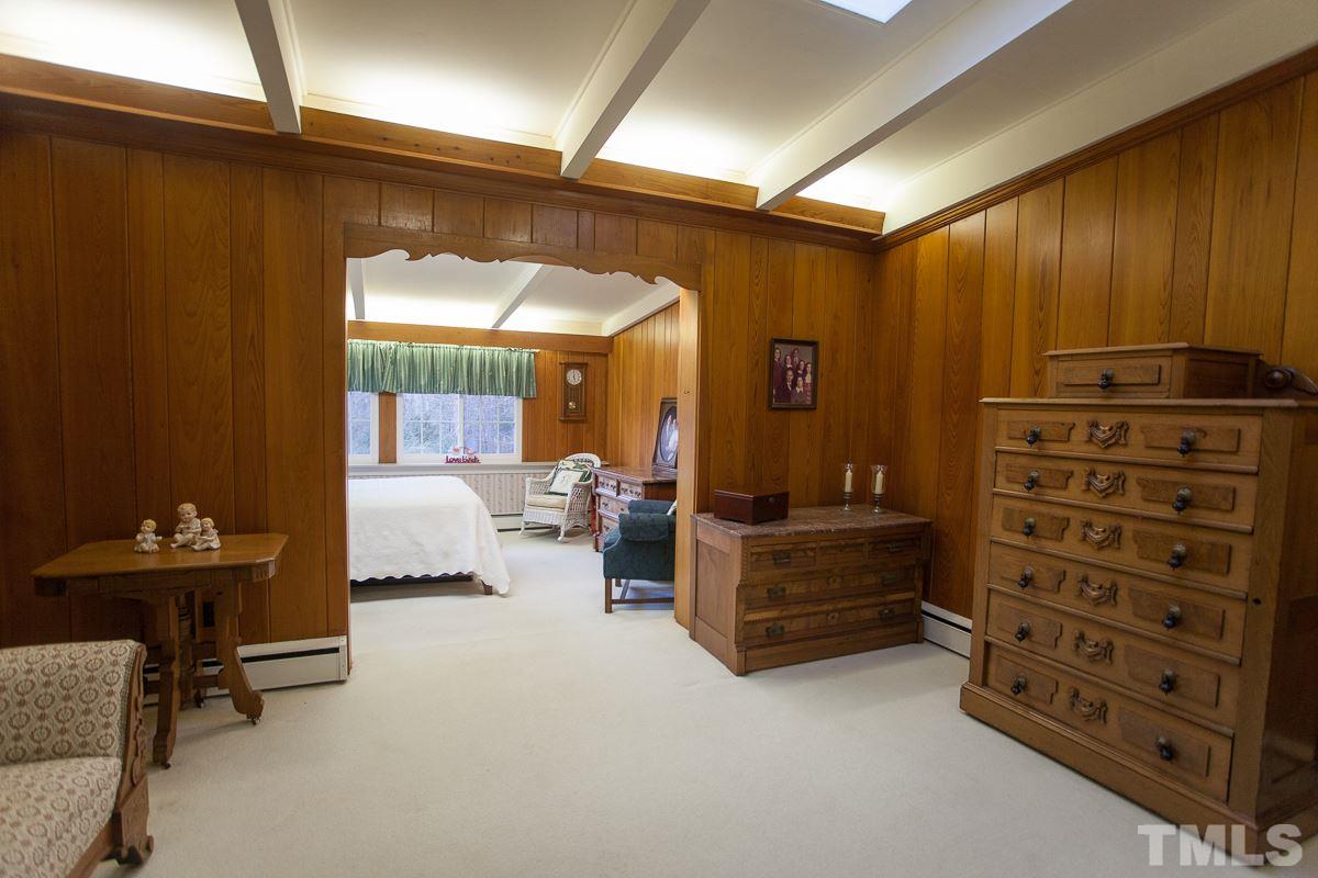 245 Weldon Wrenn Road Roxboro, NC 27574 - Photo 14 of 25 a bedroom with furniture and a large window