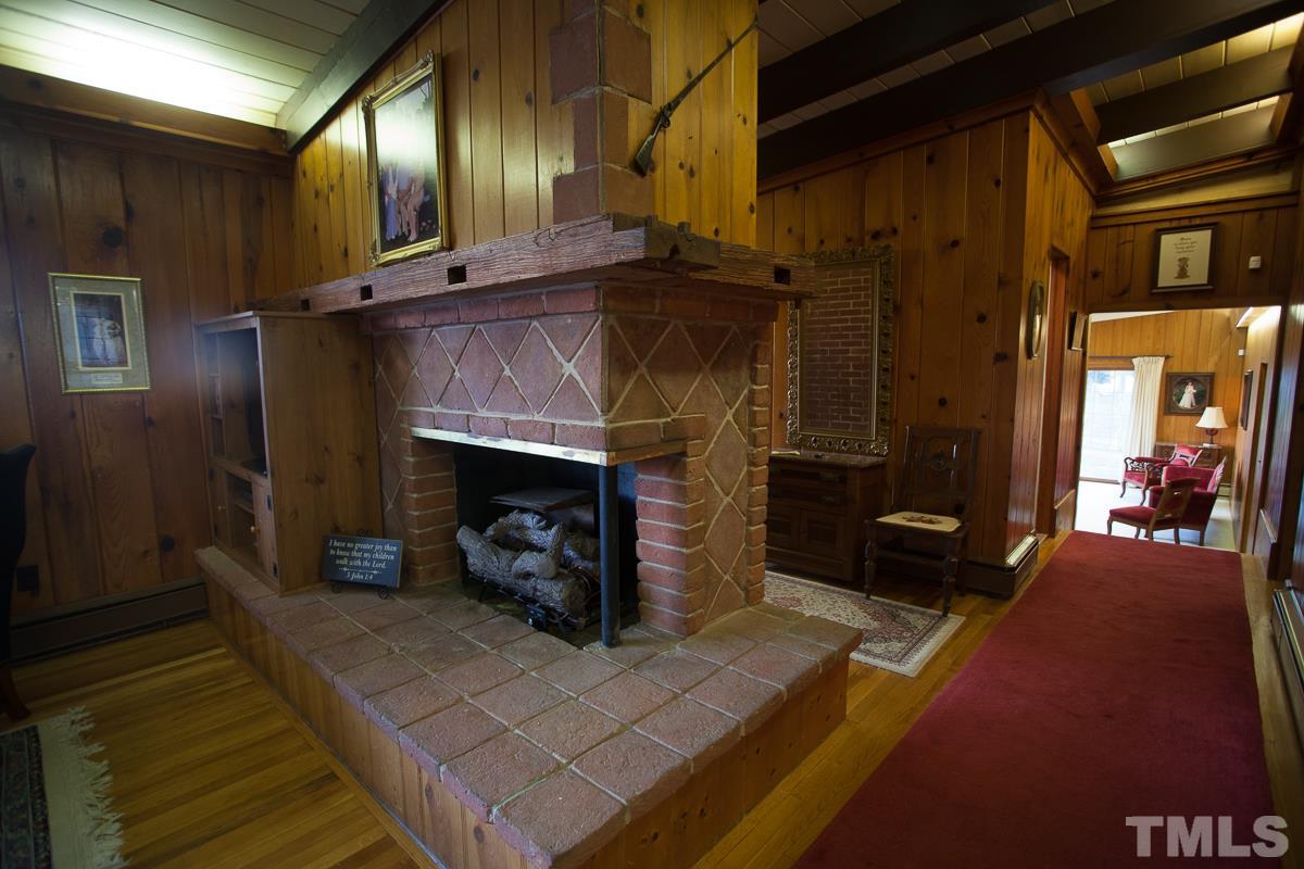 245 Weldon Wrenn Road Roxboro, NC 27574 - Photo 15 of 25 a living room with furniture and a fireplace