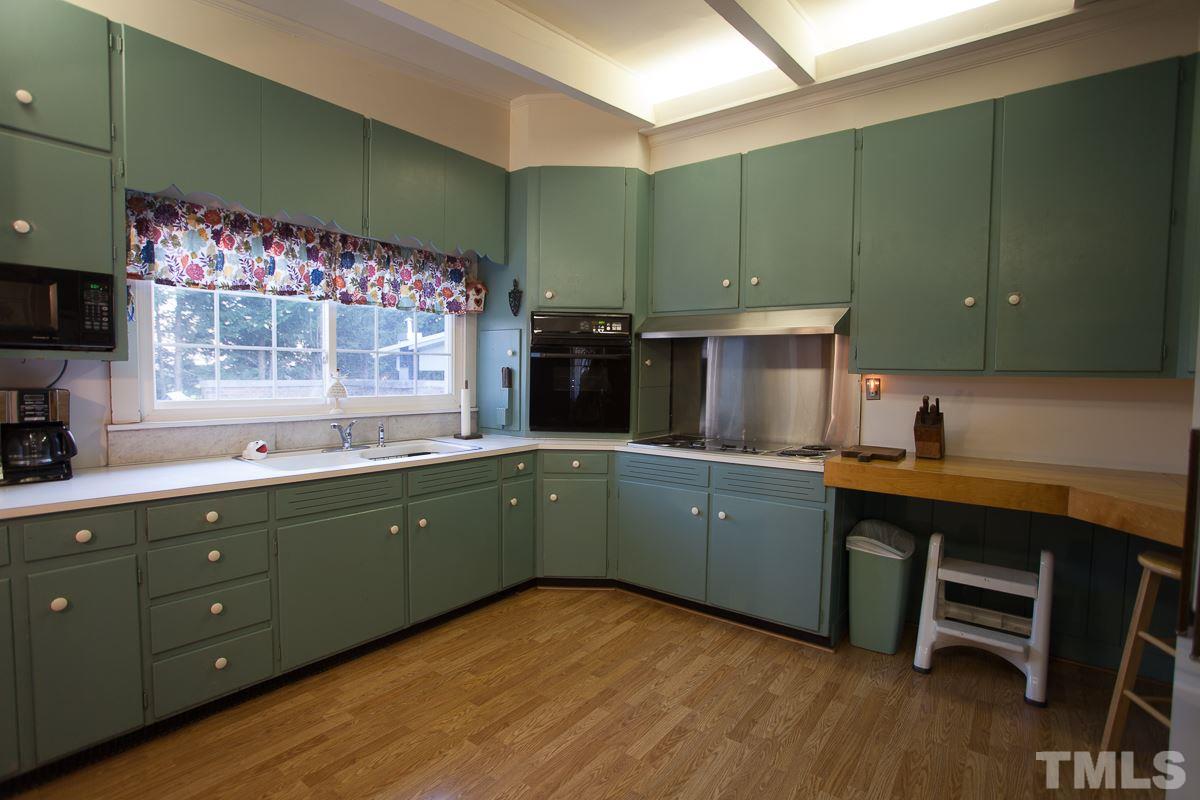 245 Weldon Wrenn Road Roxboro, NC 27574 - Photo 18 of 25 a kitchen with a sink cabinets and wooden floor