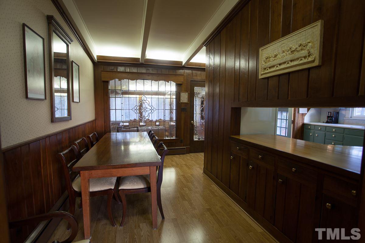245 Weldon Wrenn Road Roxboro, NC 27574 - Photo 20 of 25 a kitchen with a dining table chairs cabinets and stainless steel appliances