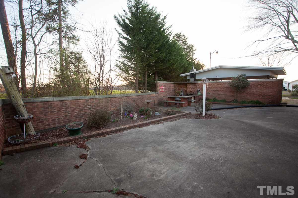 245 Weldon Wrenn Road Roxboro, NC 27574 - Photo 23 of 25 a backyard of a house with table and chairs