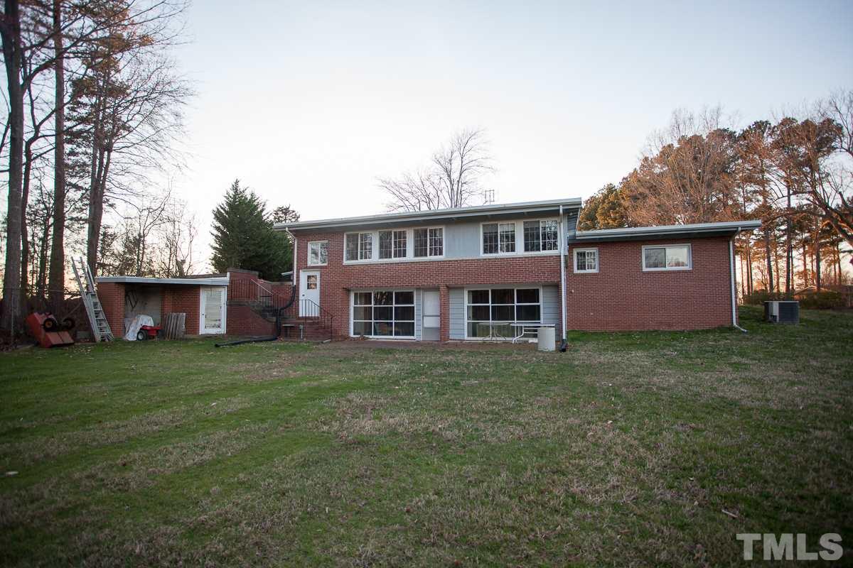 245 Weldon Wrenn Road Roxboro, NC 27574 - Photo 24 of 25 a view of a house with a yard and a garden