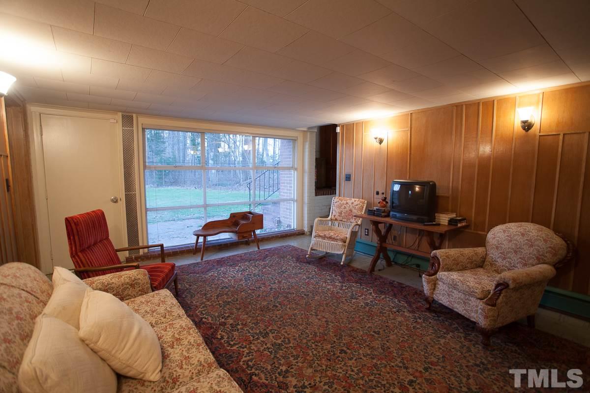 245 Weldon Wrenn Road Roxboro, NC 27574 - Photo 4 of 25 a living room with furniture and a lamp