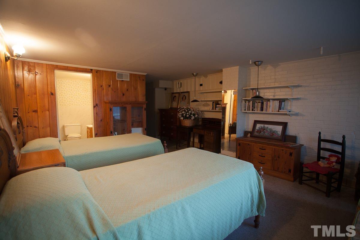245 Weldon Wrenn Road Roxboro, NC 27574 - Photo 6 of 25 a bedroom with a bed and furniture