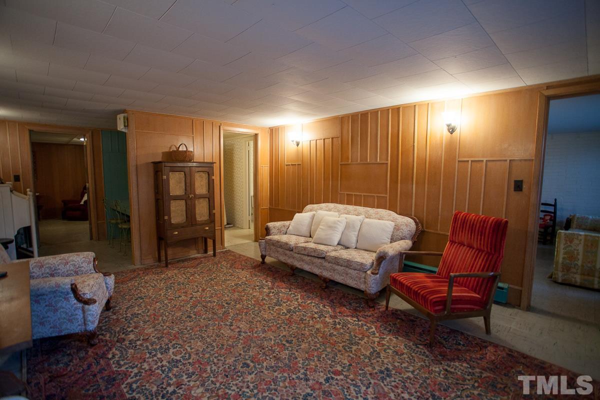 245 Weldon Wrenn Road Roxboro, NC 27574 - Photo 7 of 25 a bedroom with bed and a couch