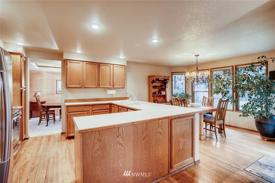 2008 238th Street Southeast Bothell, WA 98021 - Photo 3 of 25 a large kitchen with a table and chairs in it