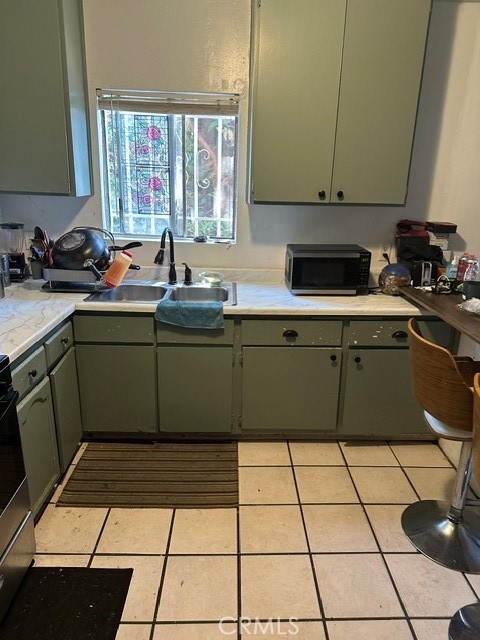 201 West Raymond Street Compton, CA 90220 - Photo 13 of 19 a kitchen with a sink and cabinets