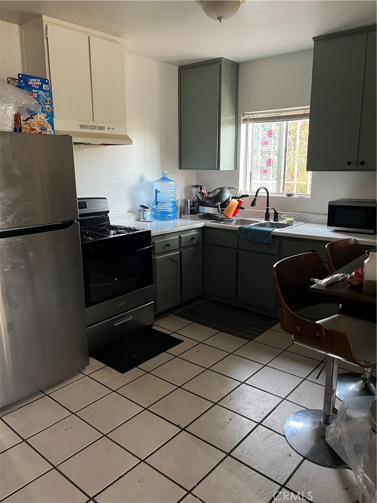 201 West Raymond Street Compton, CA 90220 - Photo 15 of 19 a kitchen with a sink appliances and cabinets