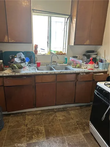 a room with granite countertop cabinets and a sink