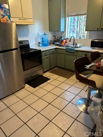 a kitchen with a sink cabinets and appliances