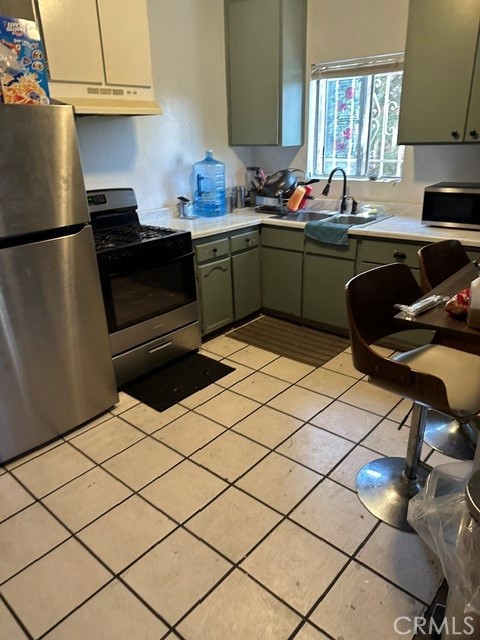 201 West Raymond Street Compton, CA 90220 - Photo 3 of 19 a kitchen with a sink cabinets and appliances