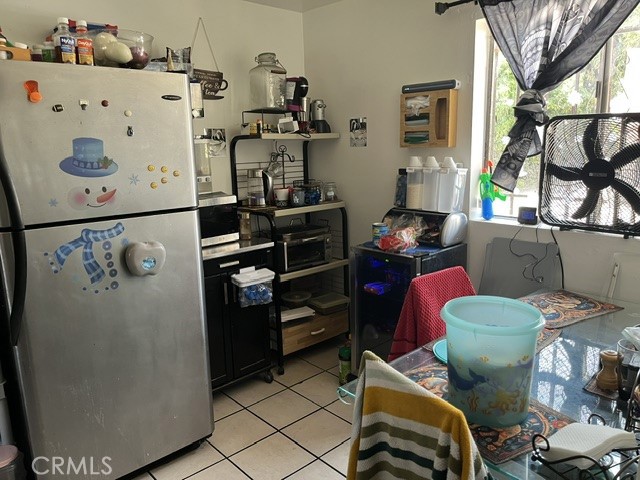 201 West Raymond Street Compton, CA 90220 - Photo 8 of 19 a kitchen with stainless steel appliances a refrigerator and a table