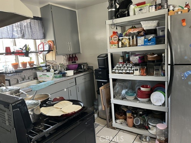 201 West Raymond Street Compton, CA 90220 - Photo 9 of 19 a room with granite countertop lots of different kinds of food