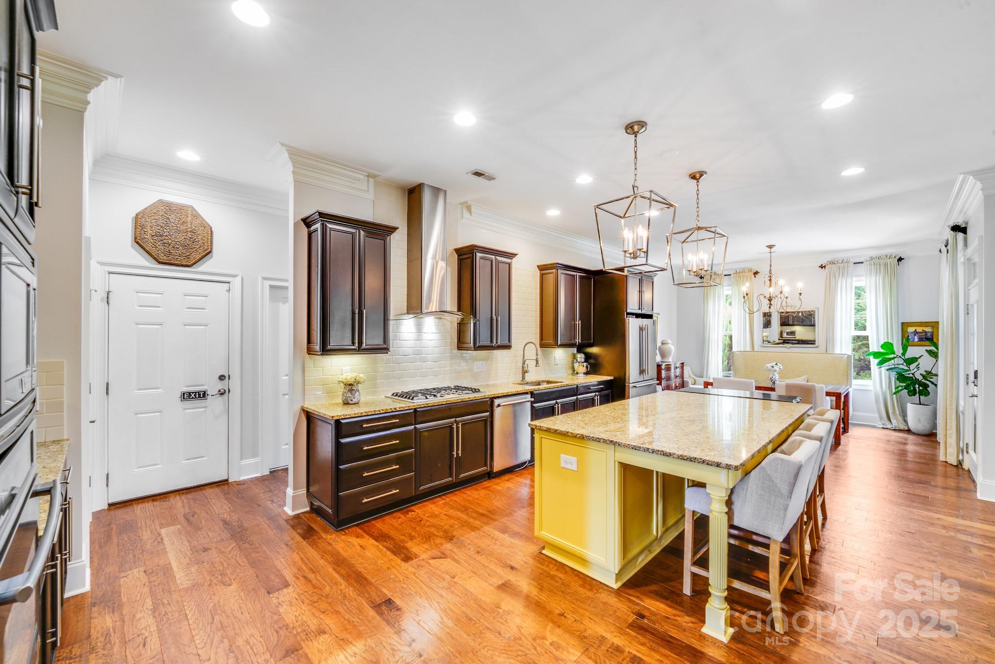 2702 Arsdale Road Waxhaw, NC 28173 - Photo 12 of 48 a kitchen with stainless steel appliances granite countertop a stove a sink a oven a dining table and chairs