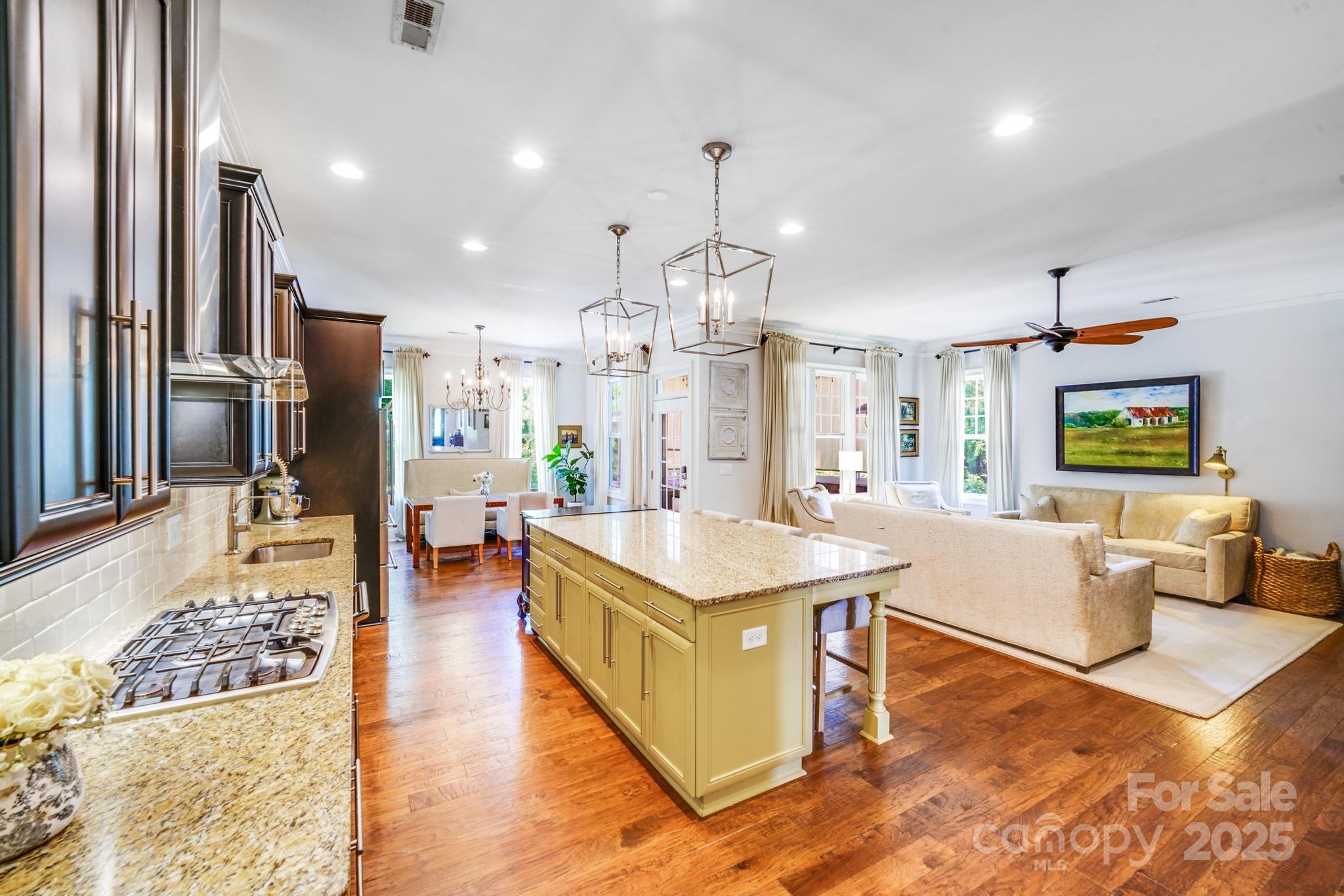 2702 Arsdale Road Waxhaw, NC 28173 - Photo 13 of 48 a living room with stainless steel appliances kitchen island granite countertop a coffee maker a sink dishwasher and a refrigerator with wooden floor