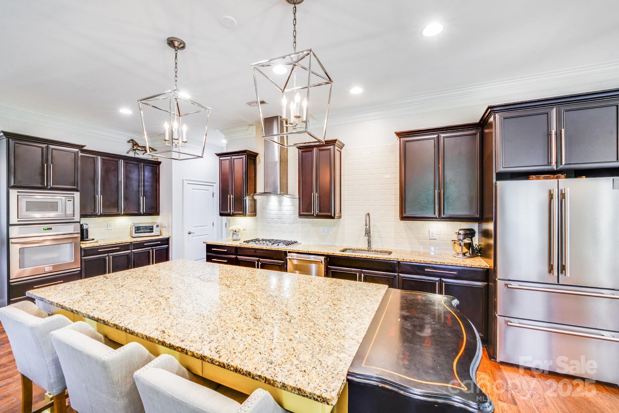 2702 Arsdale Road Waxhaw, NC 28173 - Photo 14 of 48 a kitchen with stainless steel appliances granite countertop a sink refrigerator and microwave