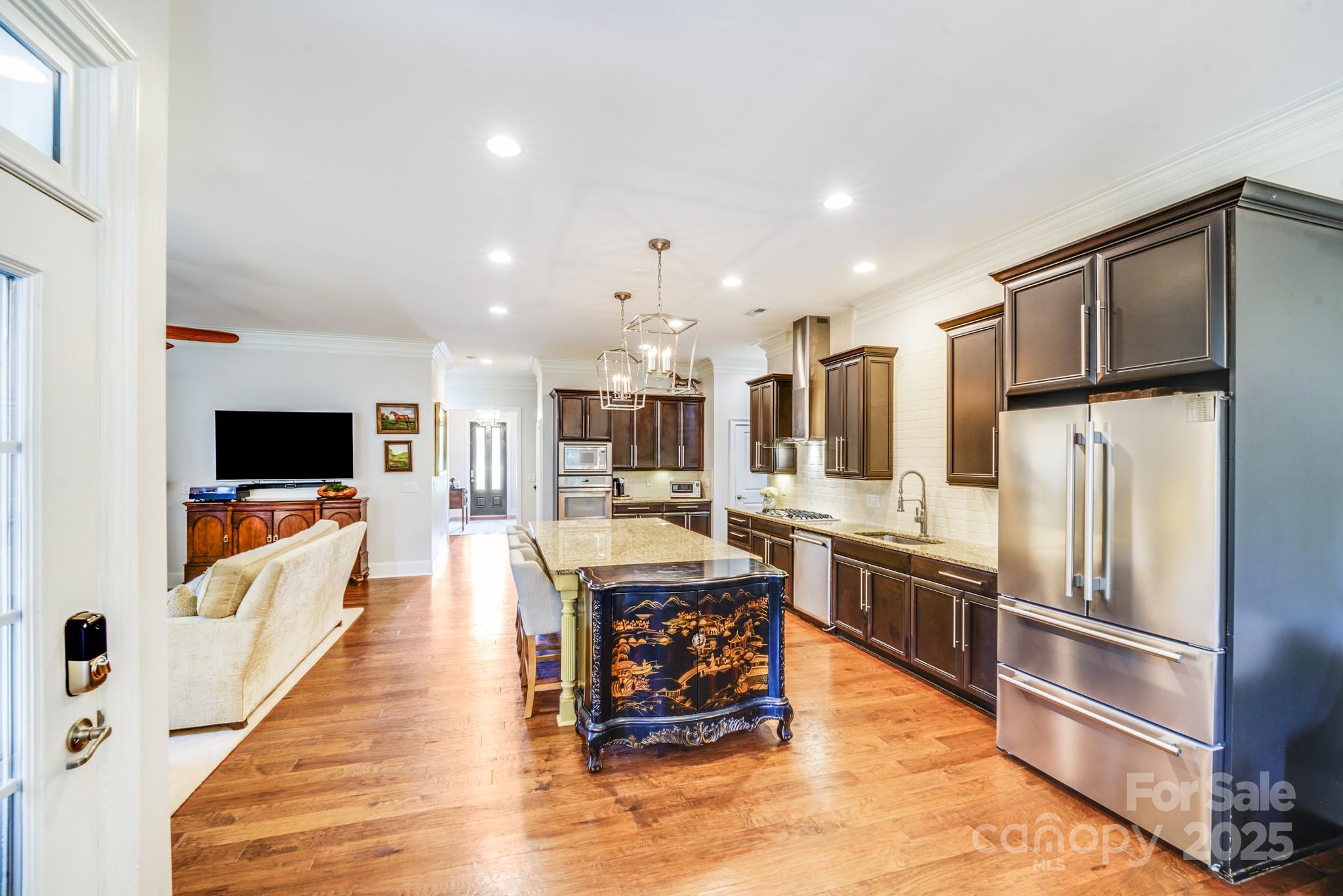 2702 Arsdale Road Waxhaw, NC 28173 - Photo 15 of 48 a large kitchen with stainless steel appliances kitchen island granite countertop a large counter top cabinetry and stainless steel appliances