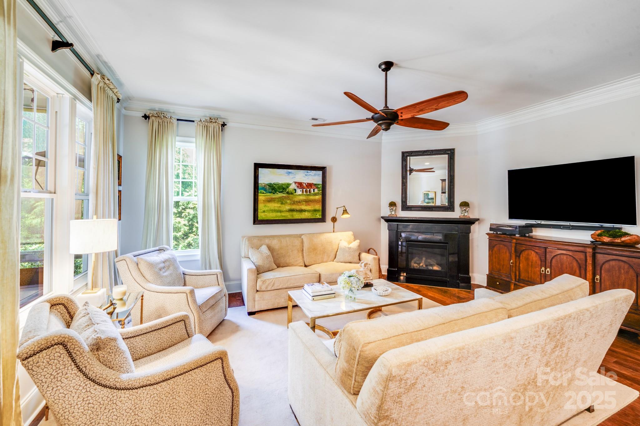 2702 Arsdale Road Waxhaw, NC 28173 - Photo 17 of 48 a living room with furniture a fireplace and a flat screen tv