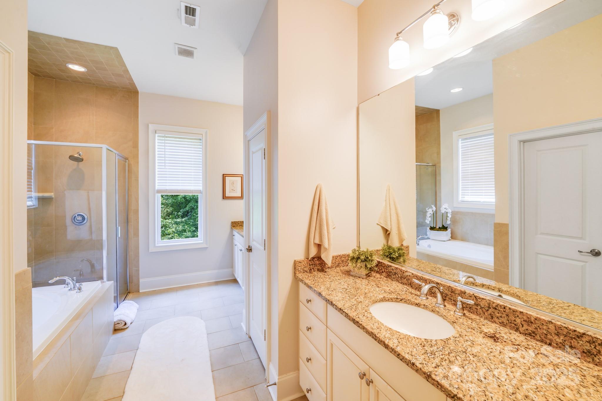 2702 Arsdale Road Waxhaw, NC 28173 - Photo 28 of 48 a spacious bathroom with a sink double vanity and a mirror