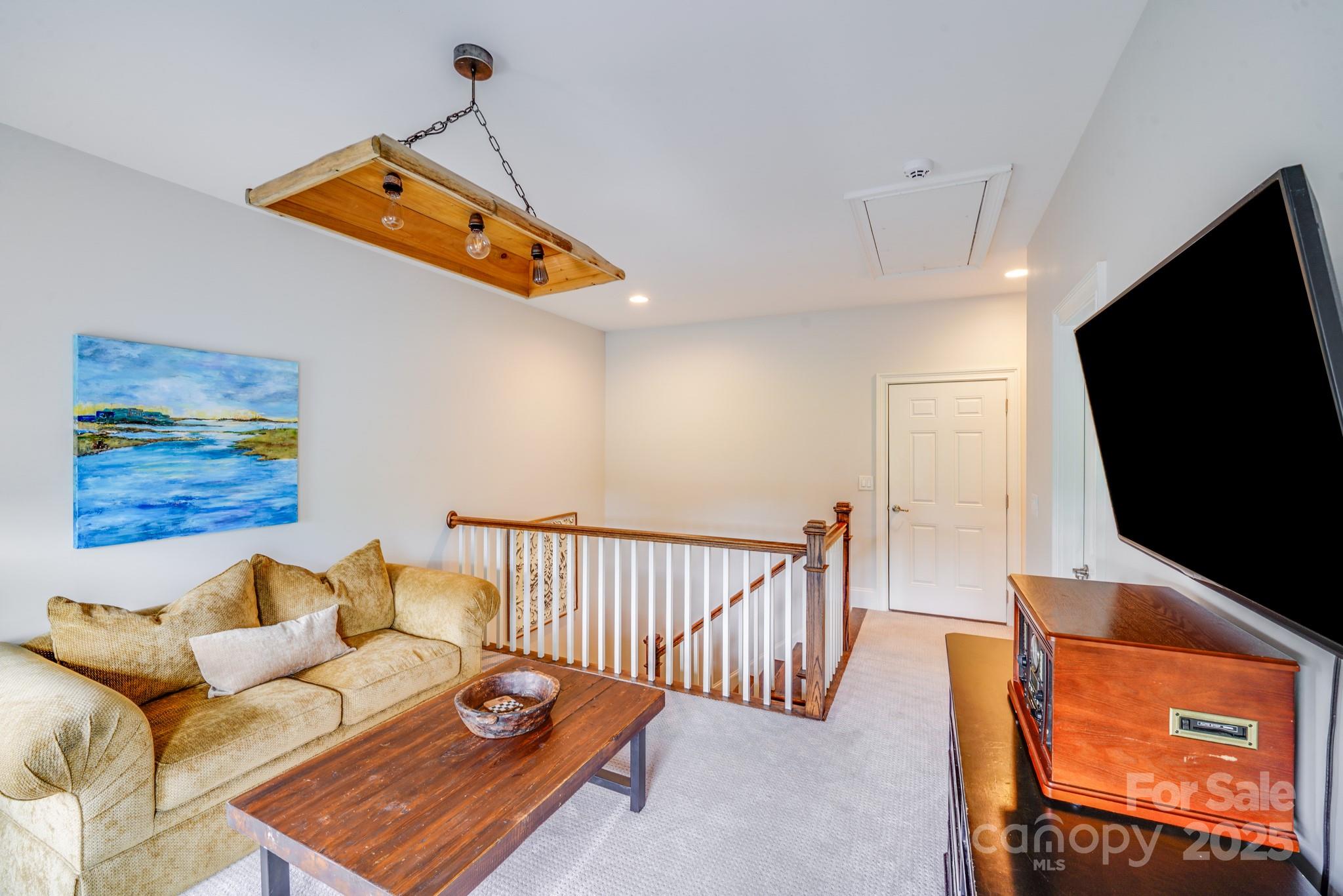 2702 Arsdale Road Waxhaw, NC 28173 - Photo 34 of 48 a living room with furniture and a flat screen tv