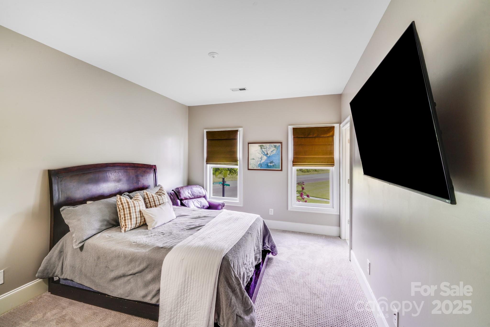 2702 Arsdale Road Waxhaw, NC 28173 - Photo 38 of 48 a bedroom with a bed and a flat tv screen on dresser