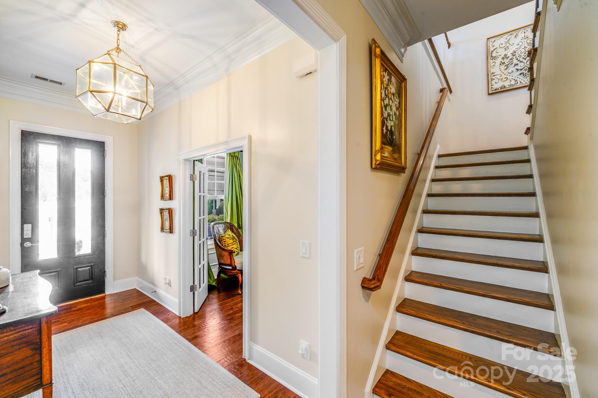 2702 Arsdale Road Waxhaw, NC 28173 - Photo 9 of 48 a view of a hallway with wooden floor and staircase