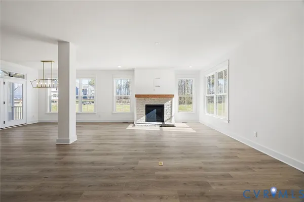 a living room with a fireplace and windows